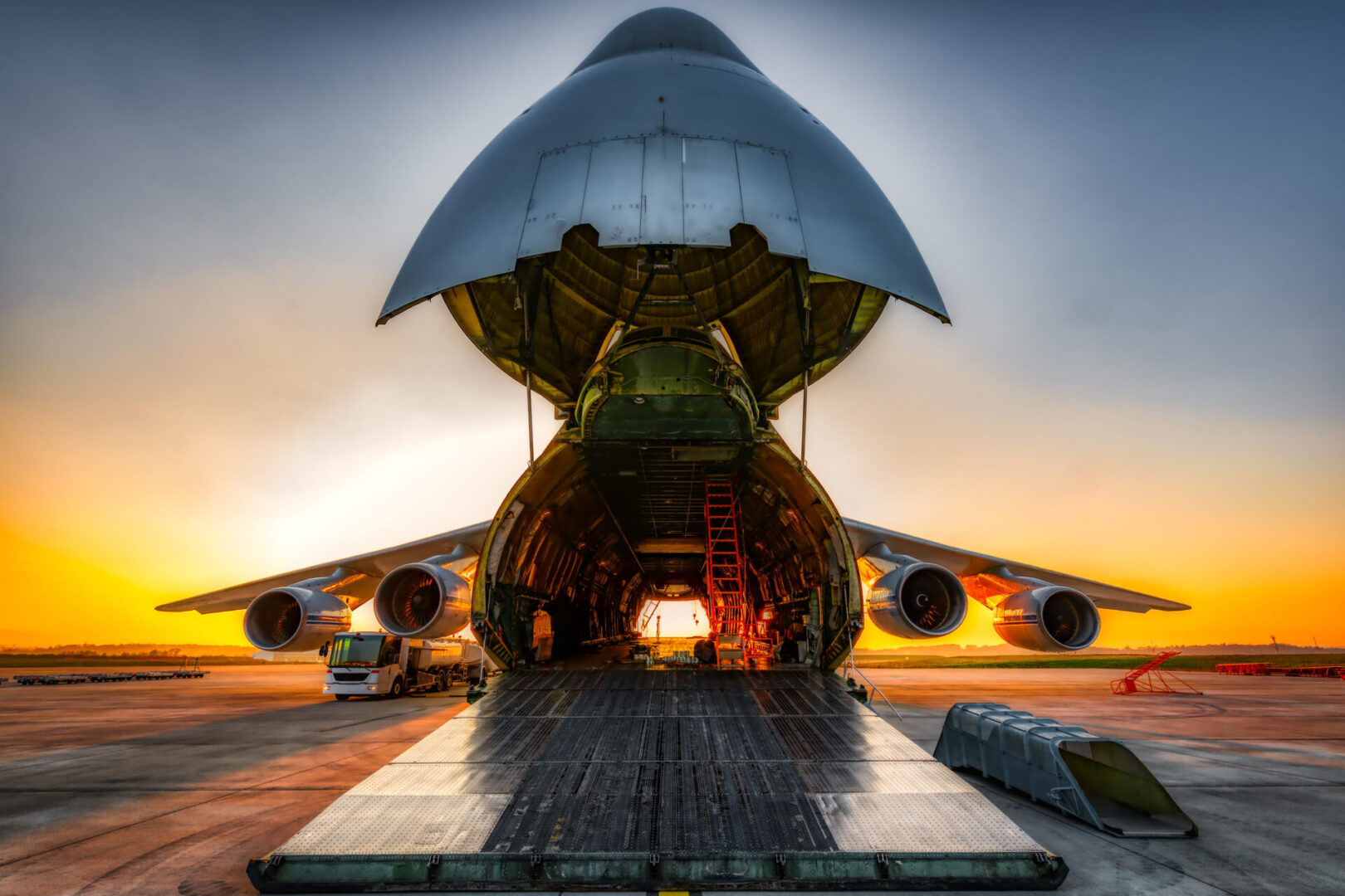 antonov an-124 on the ground with wide open freight room, fuel stop